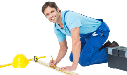 Confident worker marking on wood while measuring