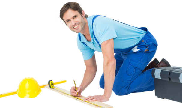 Confident worker marking on wood while measuring