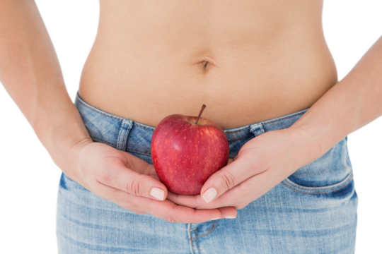 Fit woman standing with red apple