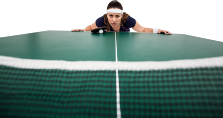 Confident female athlete leaning on hard table
