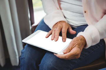 Midsection of woman using digital tablet