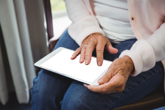 Midsection of woman using digital tablet - Powered by Adobe