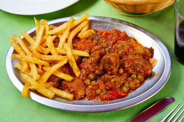 Traditional Asturian beef stewed in rustic style with gravy served with potatoes