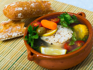 Boil the pollock head for broth. Add potatoes, carrots, shallots, corn and fillets or pollack steak...