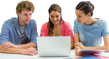 Coworkers discussing over laptop while sitting at desk