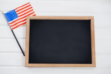 Foto op Plexiglas Amerikaanse plekken Blank chalkboard by American flag