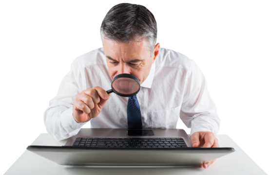 Mature businessman examining with magnifying glass