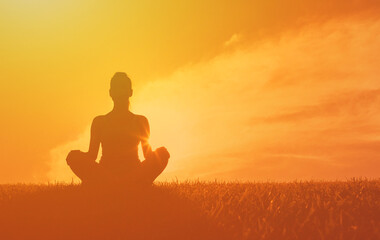 silhouette of a person meditating