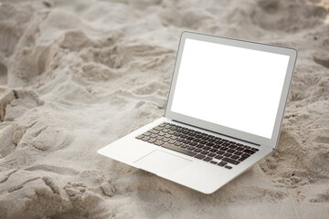 Laptop kept on sand at beach 
