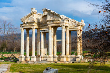 Fototapeta na wymiar Ancient ruined construction of monumental gate of small Greek city of Aphrodisias in classical architectural form of tetrapylon located in modern Aydin Province, Turkey