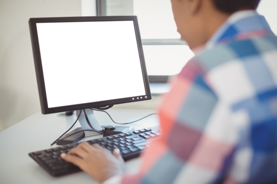 Close-up of schoolboy using computer - Powered by Adobe