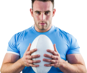 Rugby player looking at camera with ball