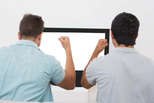 Two excited soccer fans watching tv - Powered by Adobe