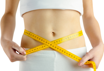 Midsection of fit woman measuring her waist
