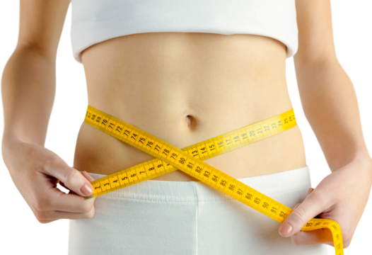 Midsection of fit woman measuring her waist