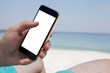 Close up of man using smartphone at beach