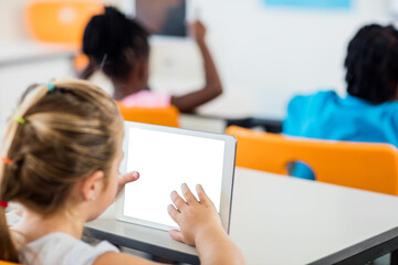 Fototapeta na wymiar Young girl using digital tablet in classroom
