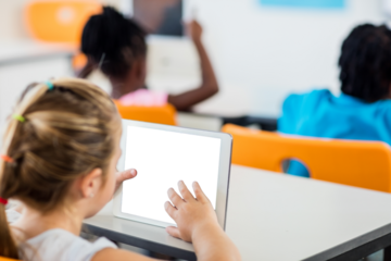 Young girl using digital tablet in classroom