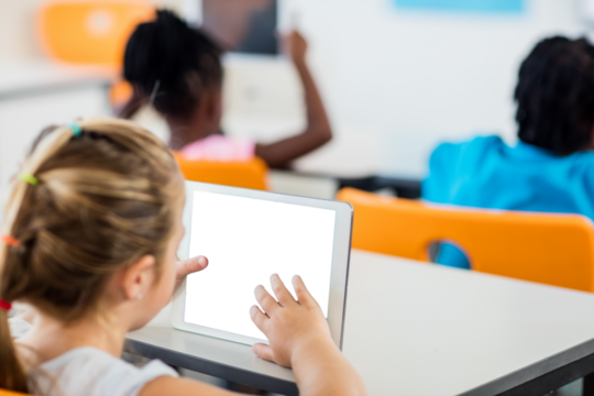 Young girl using digital tablet in classroom