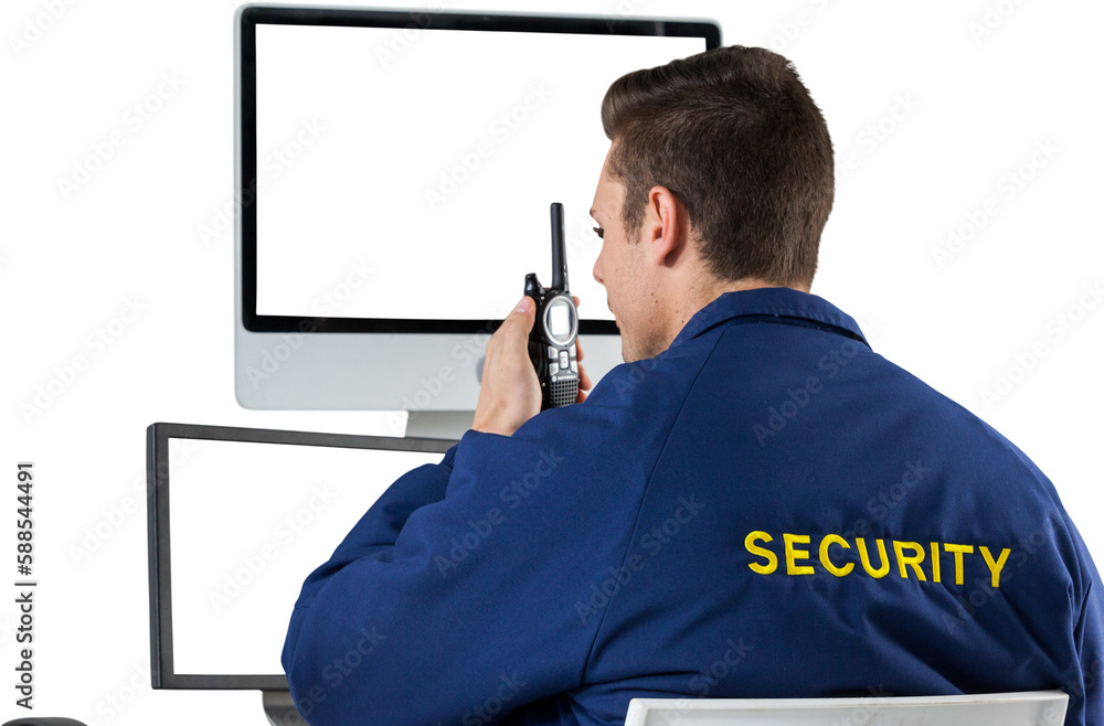 Poster security officer talking on walkie talkie while looking at computer monitors