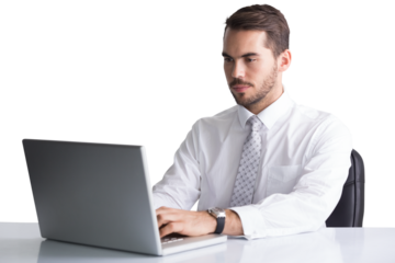 Cheerful businessman using laptop at desk 