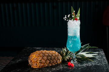 cocktail decorated with pineapple and canned cherries