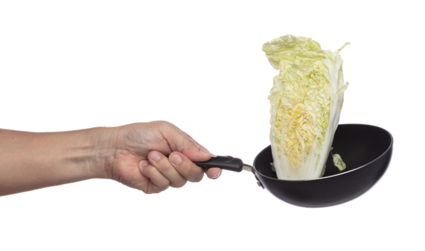 Chinese Cabbage fly fall in pan, green fresh vegetable chinese cabbage cut chop slice half. Organic fresh vegetable with eaten leaf of chinese cabbage, close up texture. White background isolated