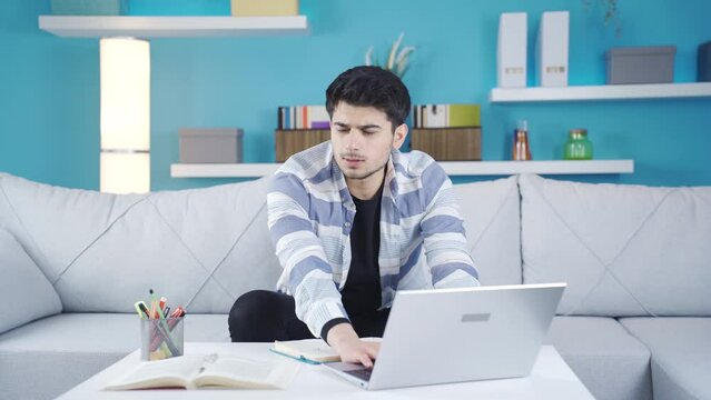 The young man is upset, remembering something he forgot.
The young man, who has a problem of forgetfulness, remembers things he needs to remember late and gets upset.

