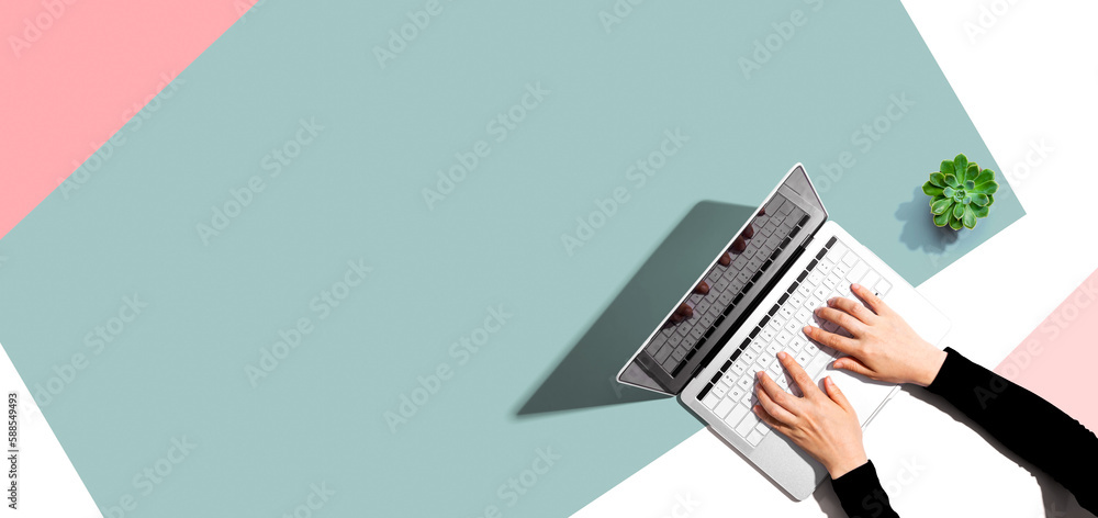 Poster person using a laptop computer from above
