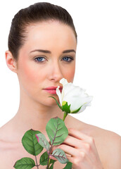 Beautiful brunette smelling white rose