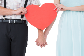 Hipster couple holding heart card