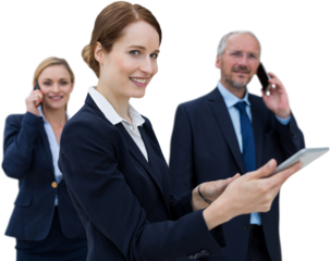 Businesswoman using tablet while colleagues talking on phone in background