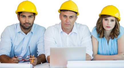 Portrait of architects wearing hardhats while sitting at table