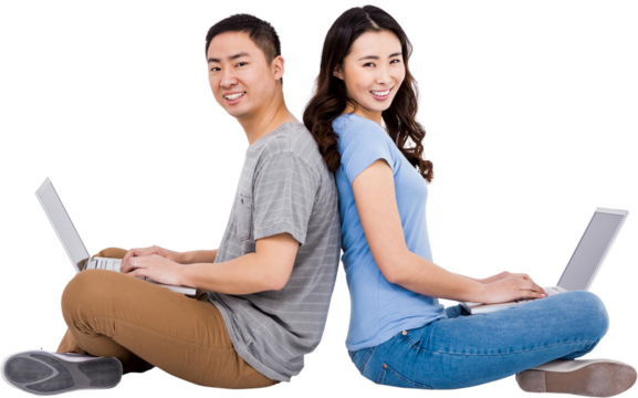 Portrait of young happy couple using laptop while sitting