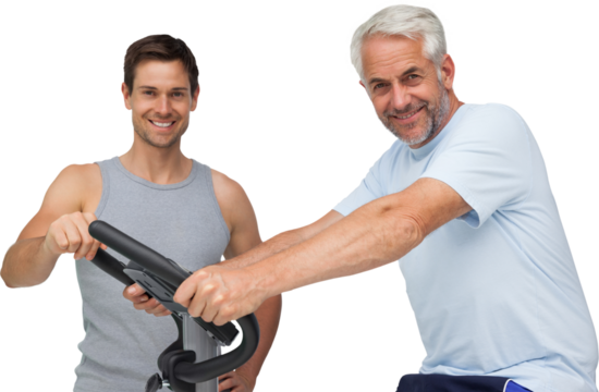 Happy mature man on stationary bike with trainer - Powered by Adobe