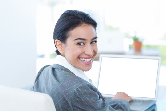 Smiling businesswoman using laptop