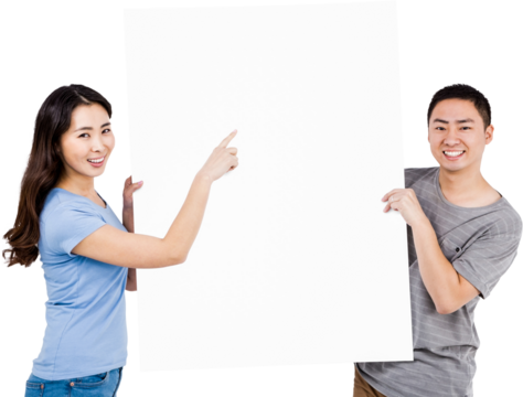 Portrait of happy young couple holding blank billboard