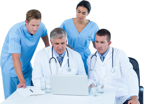 Team of doctors using laptop at desk