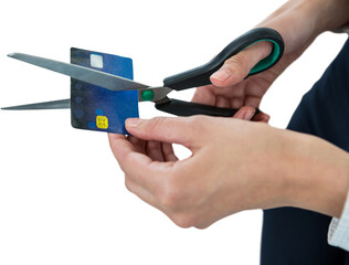 Businesswoman cutting credit card with scissors