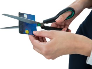 Businesswoman cutting credit card with scissors