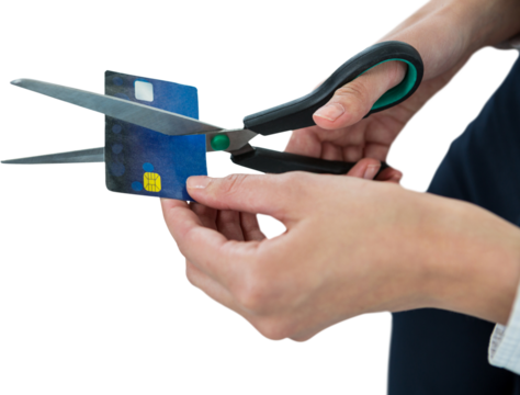 Businesswoman cutting credit card with scissors
