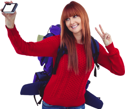 Smiling hipster woman with a travel bag taking selfie