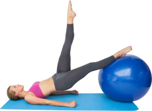 Side view of a fit woman exercising with fitness ball