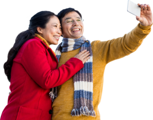 Older asian couple on balcony taking selfie