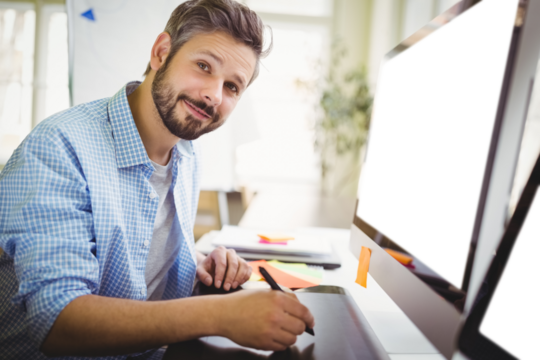 Man sitting by computer monitor at office