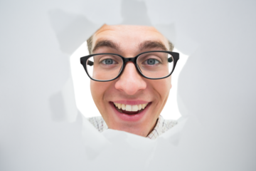 Geeky hipster smiling through hole