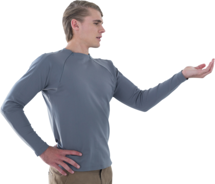 Businessman with hand on hip holding invisible product