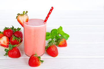 Strawberry yogurt fruit juice smoothie pink colorful fruit juice milkshake blend beverage healthy high protein the taste yummy In glass drink episode morning on white wood background.