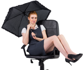 Businesswoman holding umbrella sitting on swivel chair