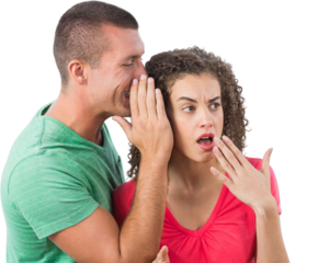 Businessman whispering secret into female colleague's ear
